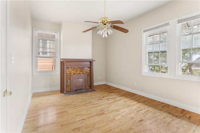 2031 General Taylor St, New Orleans, LA 70115 - unfurnished living room with wood finished floors, baseboards, a ceiling fan, and a fireplace