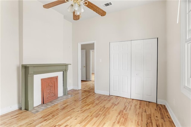 2031 General Taylor St, New Orleans, LA 70115 - unfurnished living room featuring wood finished floors, ceiling fan, baseboards, and a towering ceiling