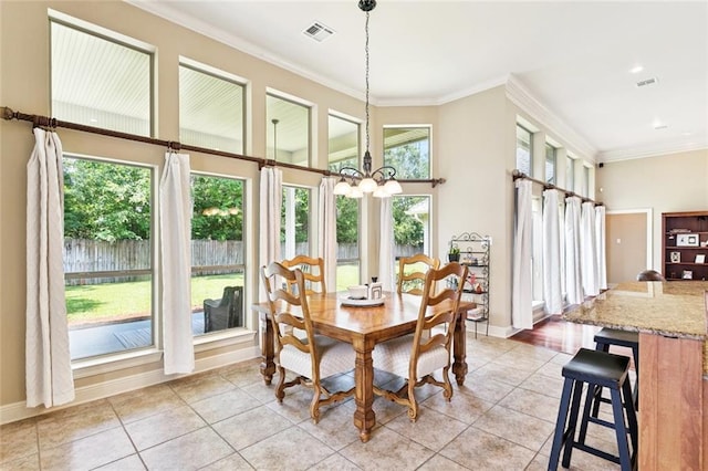 1132 Scarlet Oak Ln, Mandeville, LA 70448 - dining room with light tile patterned floors, ornamental molding, a chandelier, baseboards, and a towering ceiling
