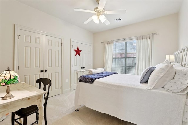 1132 Scarlet Oak Ln, Mandeville, LA 70448 - bedroom featuring multiple closets, light colored carpet, and ceiling fan