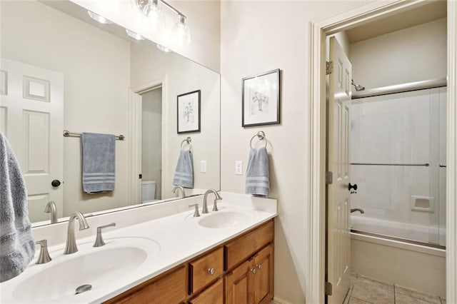 1132 Scarlet Oak Ln, Mandeville, LA 70448 - bathroom featuring bath / shower combo with glass door, toilet, double vanity, and tile patterned flooring