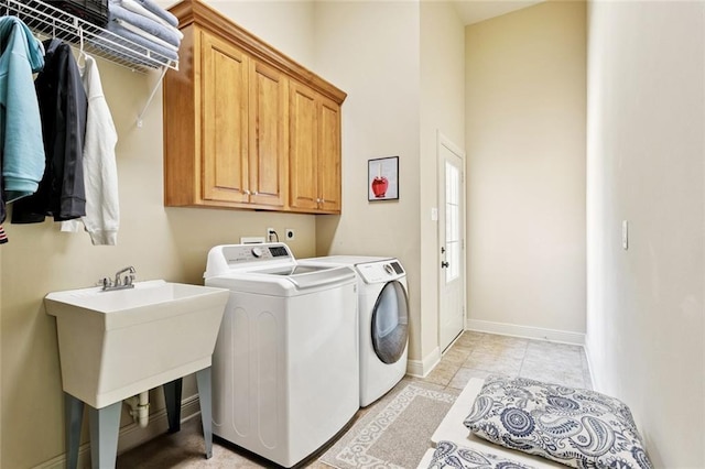 1132 Scarlet Oak Ln, Mandeville, LA 70448 - laundry area with washer and dryer, cabinet space, baseboards, light tile patterned floors, and a high ceiling