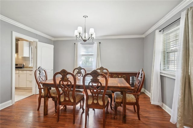 200 Pike Dr, Gretna, LA 70053 - dining room with a chandelier, ornamental molding, light wood finished floors, and baseboards