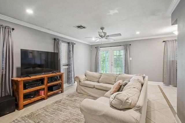 200 Pike Dr, Gretna, LA 70053 - living area with tile patterned flooring, a ceiling fan, ornamental molding, baseboards, and recessed lighting