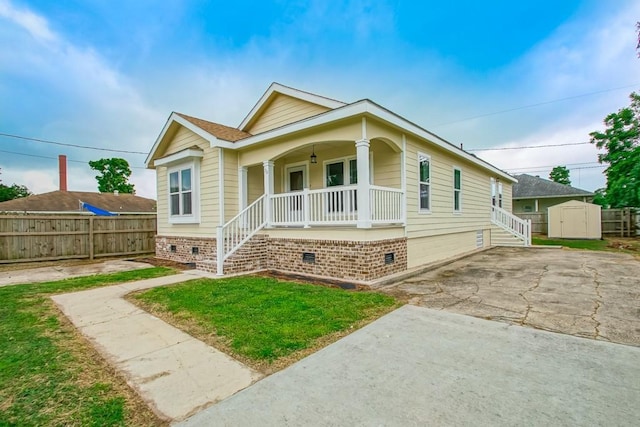 70 Old Hickory St, Chalmette, LA 70043 - view of front facade with covered porch, crawl space, stairway, and concrete driveway
