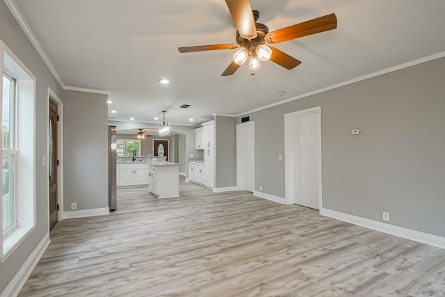 70 Old Hickory St, Chalmette, LA 70043 - unfurnished living room with a ceiling fan, light wood-style flooring, crown molding, recessed lighting, and baseboards
