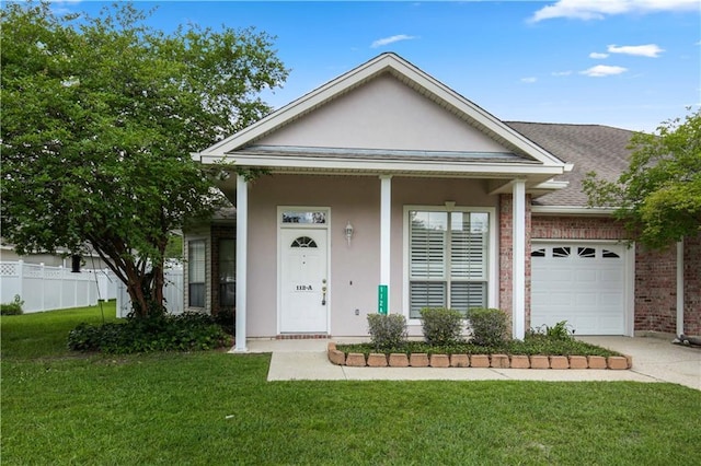 112 Short St Unit A, Slidell, LA 70461 - view of front facade featuring an attached garage, driveway, brick siding, stucco siding, and roof with shingles
