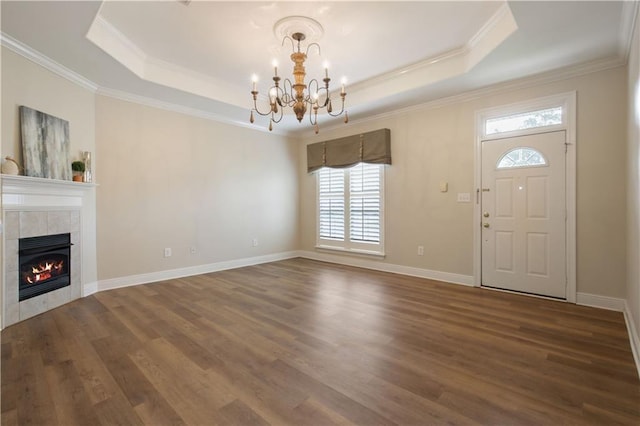 112 Short St Unit A, Slidell, LA 70461 - unfurnished living room with a tray ceiling, dark wood finished floors, crown molding, a chandelier, and a tile fireplace