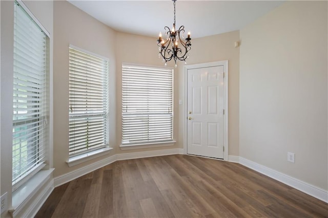 112 Short St Unit A, Slidell, LA 70461 - unfurnished dining area featuring a chandelier, wood finished floors, and baseboards