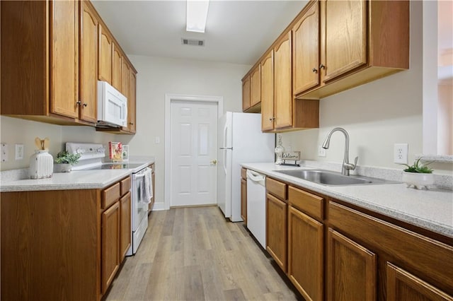 112 Short St Unit A, Slidell, LA 70461 - kitchen featuring white appliances, a sink, light wood-style flooring, light countertops, and brown cabinets