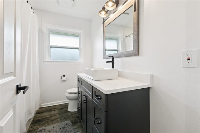 6200 Leslie St, Metairie, LA 70003 - full bath with vanity, wood finished floors, toilet, and baseboards