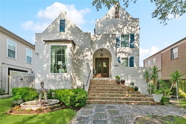 6838 Catina St, New Orleans, LA 70124 - view of front of house with stucco siding and french doors