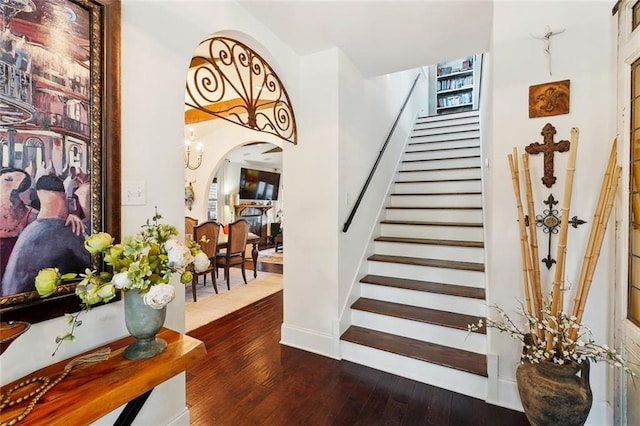 6838 Catina St, New Orleans, LA 70124 - stairs with hardwood / wood-style flooring, arched walkways, and baseboards