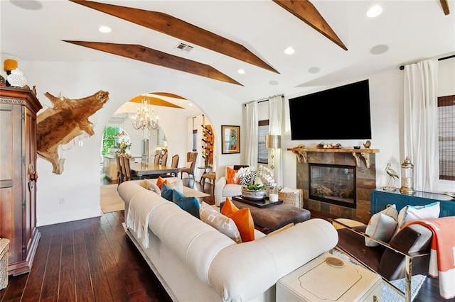 6838 Catina St, New Orleans, LA 70124 - living room with arched walkways, recessed lighting, a glass covered fireplace, hardwood / wood-style flooring, and a chandelier
