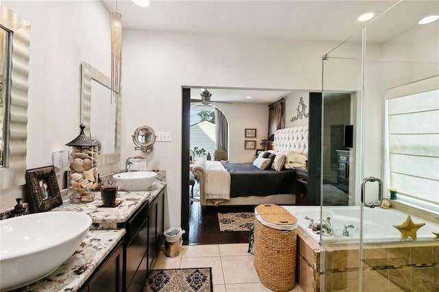 6838 Catina St, New Orleans, LA 70124 - bathroom featuring ensuite bath, double vanity, a garden tub, tile patterned floors, and a shower stall
