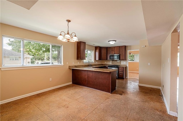 966-968 Allen Toussaint Blvd, New Orleans, LA 70124 - kitchen featuring stainless steel appliances, a peninsula, baseboards, and a chandelier