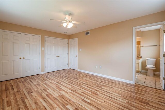 966-968 Allen Toussaint Blvd, New Orleans, LA 70124 - unfurnished bedroom featuring light wood-style flooring, two closets, baseboards, and connected bathroom