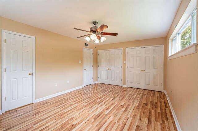 966-968 Allen Toussaint Blvd, New Orleans, LA 70124 - unfurnished bedroom featuring light wood finished floors, two closets, baseboards, and ceiling fan