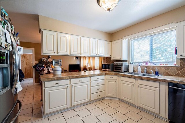 966-968 Allen Toussaint Blvd, New Orleans, LA 70124 - kitchen with stainless steel appliances, a peninsula, a sink, and white cabinets