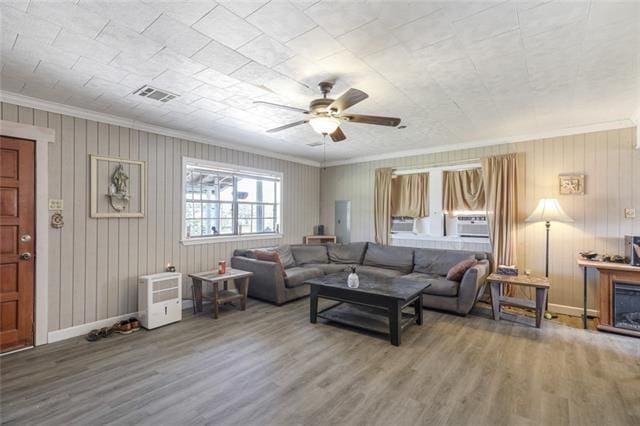 5679 Jean Lafitte Blvd, Jean Lafitte, LA 70067 - living area with ornamental molding, wood finished floors, ceiling fan, and baseboards
