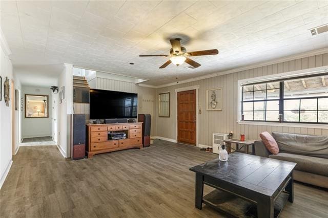 5679 Jean Lafitte Blvd, Jean Lafitte, LA 70067 - living room featuring ceiling fan, baseboards, wood finished floors, and ornamental molding