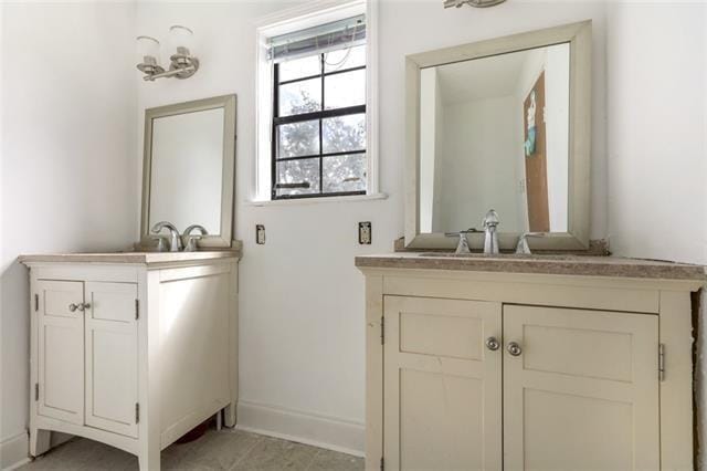 5679 Jean Lafitte Blvd, Jean Lafitte, LA 70067 - bathroom with two vanities and baseboards