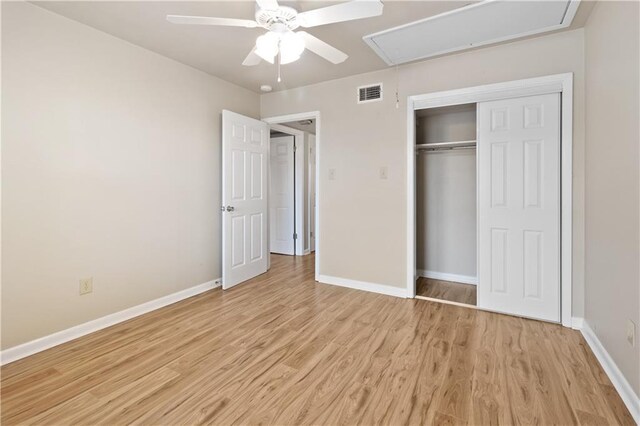 2713 Independence St, Metairie, LA 70006 - unfurnished bedroom featuring attic access, light wood-style flooring, baseboards, a closet, and a ceiling fan