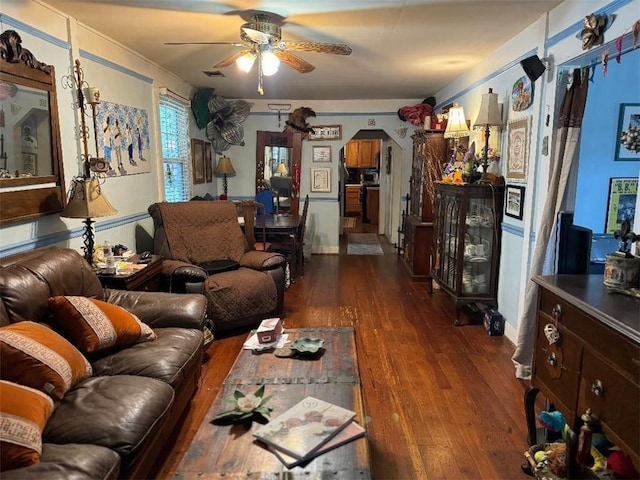 5621 Tchoupitoulas St, New Orleans, LA 70115 - living room featuring a ceiling fan, dark wood finished floors, and arched walkways