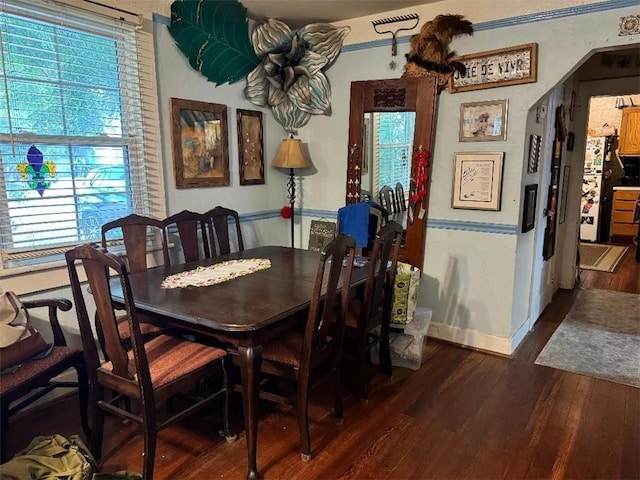 5621 Tchoupitoulas St, New Orleans, LA 70115 - dining space featuring wood finished floors and arched walkways