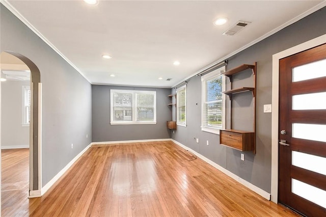 226 Lions St, Jefferson, LA 70121 - foyer with arched walkways, crown molding, light wood finished floors, and recessed lighting