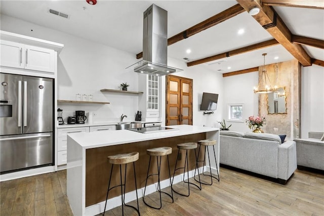 1416 Bourbon St Unit 5, New Orleans, LA 70116 - kitchen featuring stainless steel refrigerator with ice dispenser, island range hood, open floor plan, light wood-style flooring, and open shelves