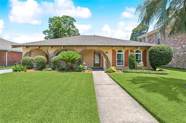 4517 Bissonet Dr, Metairie, LA 70003 - ranch-style home featuring brick siding, a front yard, and a shingled roof