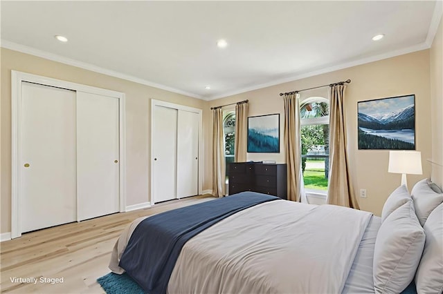 4517 Bissonet Dr, Metairie, LA 70003 - bedroom with light wood-type flooring, two closets, recessed lighting, and crown molding