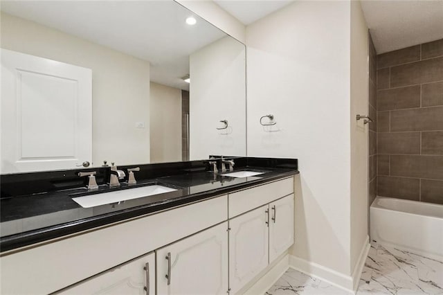 4517 Bissonet Dr, Metairie, LA 70003 - bathroom featuring baseboards, marble look tiles, double vanity, recessed lighting, and  shower combination