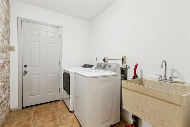 4517 Bissonet Dr, Metairie, LA 70003 - laundry room featuring separate washer and dryer, light tile patterned floors, and brick wall