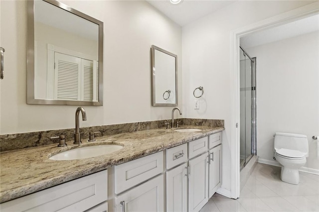 4517 Bissonet Dr, Metairie, LA 70003 - full bath with toilet, a stall shower, double vanity, baseboards, and tile patterned flooring
