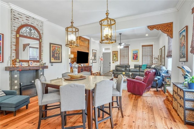 205 S Norman C Francis Pkwy, New Orleans, LA 70119 - dining area with light wood-style flooring, a ceiling fan, a fireplace, and crown molding