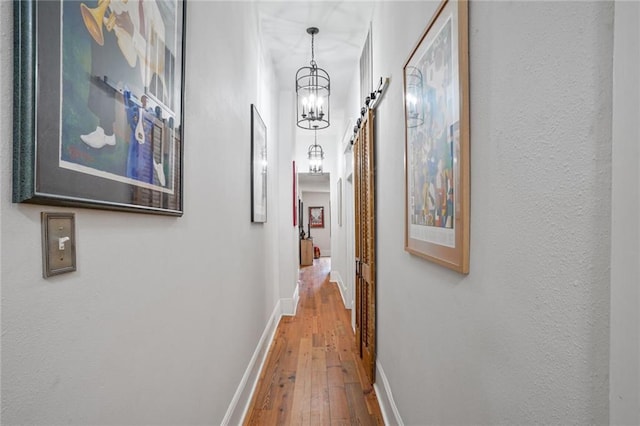 205 S Norman C Francis Pkwy, New Orleans, LA 70119 - hall with hardwood / wood-style floors, a chandelier, and baseboards