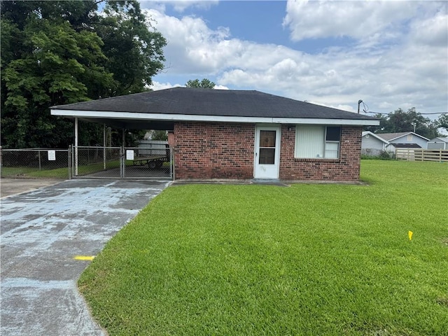 136 5th St, Bridge City, LA 70094 - view of front of house featuring concrete driveway, brick siding, a gate, and an attached carport