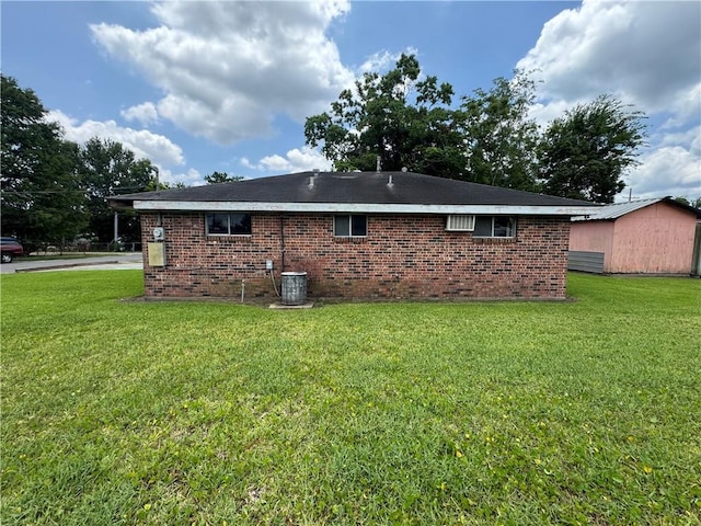 136 5th St, Bridge City, LA 70094 - rear view of house featuring a yard, brick siding, and cooling unit