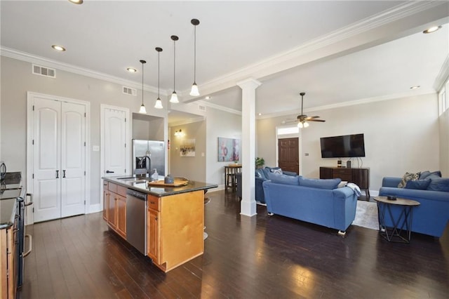3445 Magnolia St, New Orleans, LA 70115 - kitchen featuring open floor plan, appliances with stainless steel finishes, a sink, ceiling fan, and brown cabinetry
