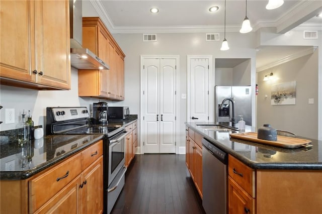 3445 Magnolia St, New Orleans, LA 70115 - kitchen with stainless steel appliances, wall chimney range hood, a sink, a kitchen island with sink, and dark wood finished floors