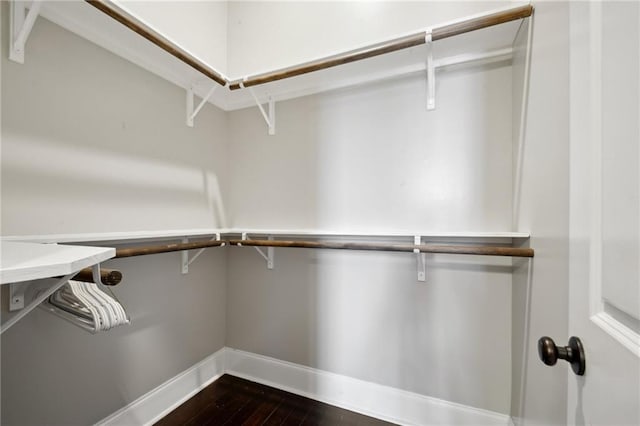 3445 Magnolia St, New Orleans, LA 70115 - walk in closet with dark wood-style floors