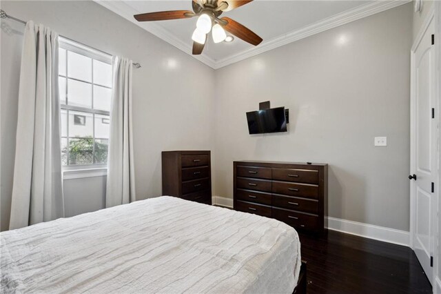 3445 Magnolia St, New Orleans, LA 70115 - bedroom with baseboards, dark wood-style floors, crown molding, and a ceiling fan