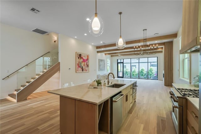 7104 Coliseum St, New Orleans, LA 70118 - kitchen featuring a sink, stainless steel appliances, light wood-style flooring, an island with sink, and recessed lighting