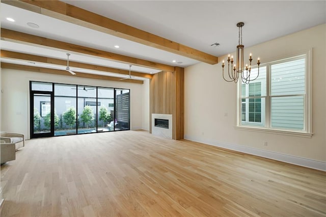 7104 Coliseum St, New Orleans, LA 70118 - unfurnished living room with beamed ceiling, baseboards, light wood-style floors, a chandelier, and a glass covered fireplace