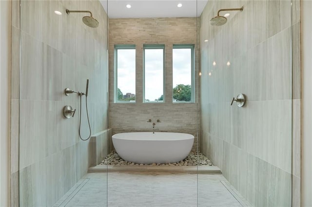 7104 Coliseum St, New Orleans, LA 70118 - bathroom with tile walls, a tile shower, and a soaking tub