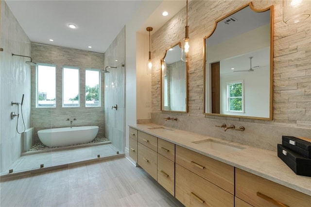 7104 Coliseum St, New Orleans, LA 70118 - bathroom with a soaking tub, double vanity, tiled shower, a ceiling fan, and backsplash