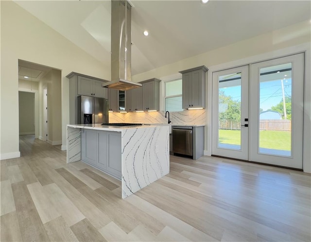 1421 David Dr, Metairie, LA 70003 - kitchen with gray cabinetry, stainless steel appliances, island range hood, vaulted ceiling, and french doors