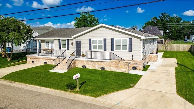 234 Murray Hill Dr, Destrehan, LA 70047 - ranch-style house with concrete driveway, a front yard, a porch, and stairway